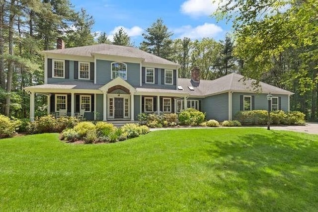 51 Fox Run Rd, Sudbury, MA 01776 - colonial home featuring a chimney and a front yard