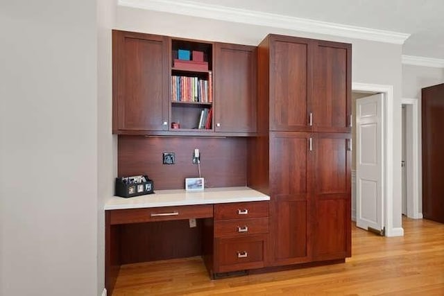 51 Fox Run Rd, Sudbury, MA 01776 - kitchen featuring built in study area, ornamental molding, light countertops, open shelves, and light wood-style flooring