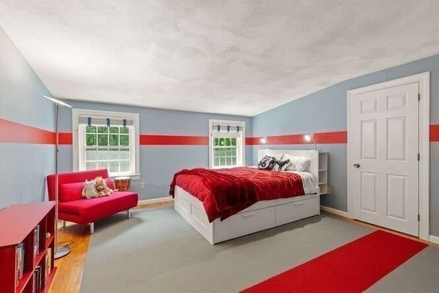51 Fox Run Rd, Sudbury, MA 01776 - bedroom with multiple windows, vaulted ceiling, and wood finished floors