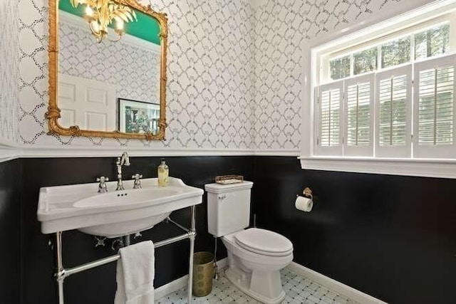 51 Fox Run Rd, Sudbury, MA 01776 - bathroom featuring healthy amount of natural light, wallpapered walls, and a wainscoted wall