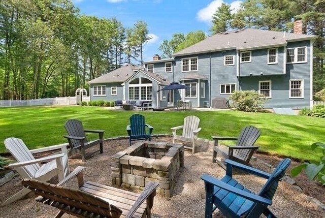 51 Fox Run Rd, Sudbury, MA 01776 - back of house featuring a fire pit and a chimney