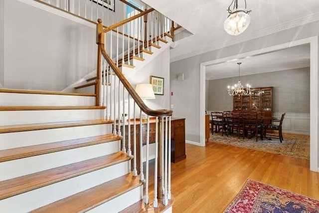 51 Fox Run Rd, Sudbury, MA 01776 - stairs with a chandelier, wood finished floors, crown molding, and a wainscoted wall