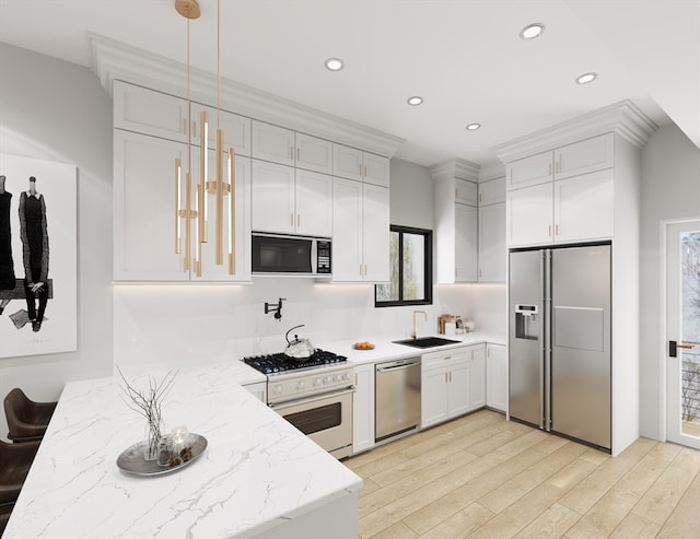 kitchen featuring pendant lighting, white cabinetry, stainless steel appliances, and light hardwood / wood-style flooring