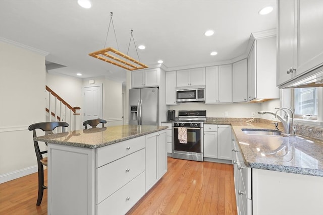 21 Pine St Unit 1A, Falmouth, MA 02556 - kitchen featuring stainless steel appliances, recessed lighting, a kitchen bar, a kitchen island, and light wood finished floors