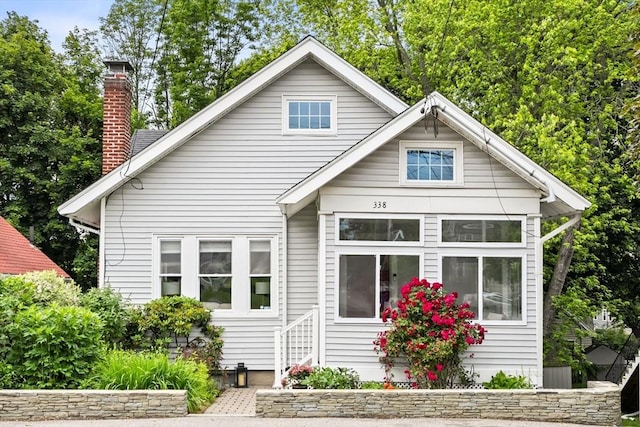 338 Forest St, Arlington, MA 02474 - bungalow-style house with a chimney and entry steps