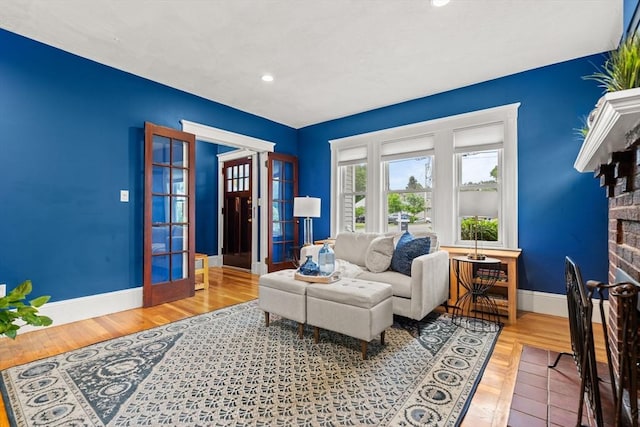 338 Forest St, Arlington, MA 02474 - living room with wood finished floors, recessed lighting, a fireplace, and french doors