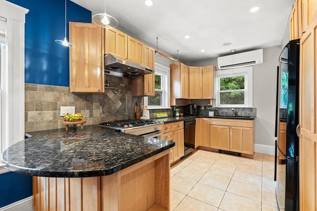 338 Forest St, Arlington, MA 02474 - kitchen with an AC wall unit, under cabinet range hood, black appliances, light brown cabinetry, and recessed lighting