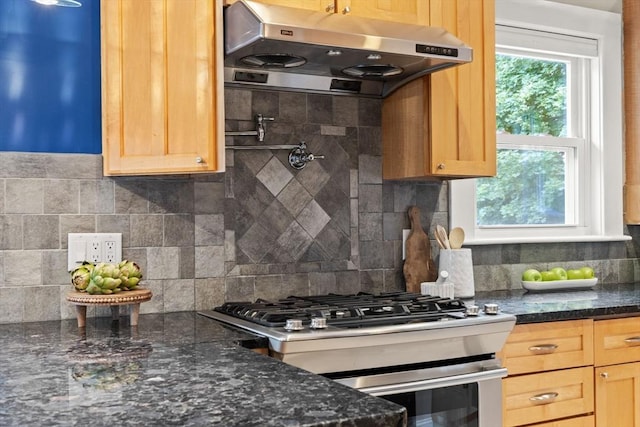 338 Forest St, Arlington, MA 02474 - kitchen featuring range hood, stainless steel range with gas cooktop, backsplash, and dark stone counters
