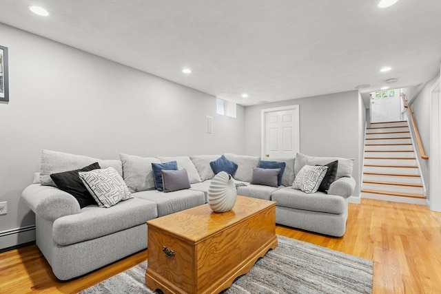 338 Forest St, Arlington, MA 02474 - living room featuring light wood-style floors, recessed lighting, stairway, a baseboard radiator, and healthy amount of natural light