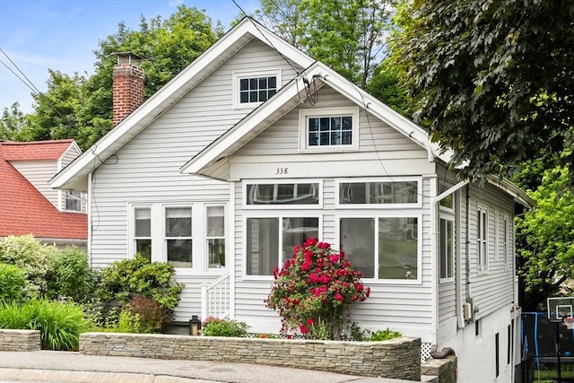 338 Forest St, Arlington, MA 02474 - view of front facade featuring a chimney