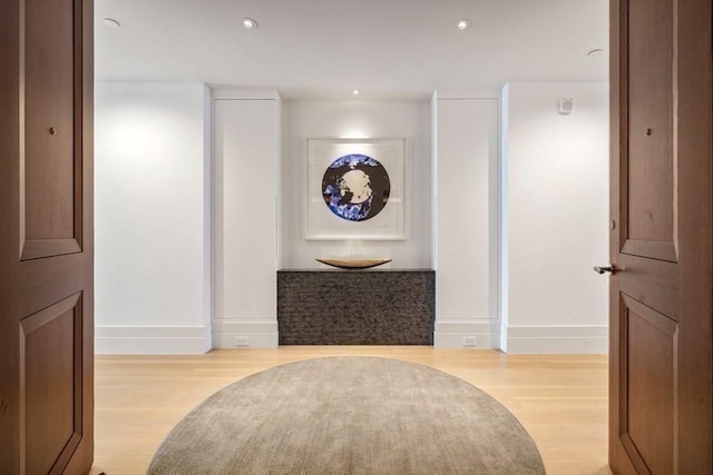 hall with baseboards, wood finished floors, and recessed lighting