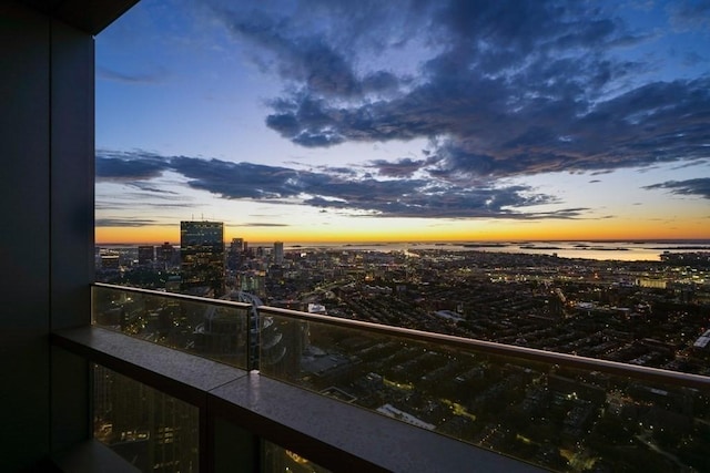 balcony at dusk with a view of city