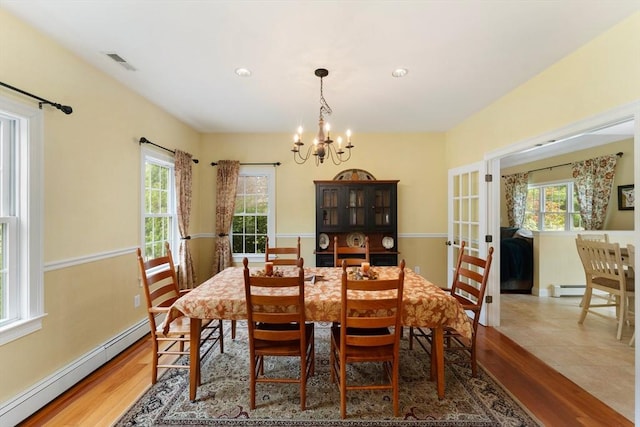 55 Arbor Rd, Uxbridge, MA 01569 - dining area featuring a baseboard heating unit, a chandelier, wood finished floors, and baseboards