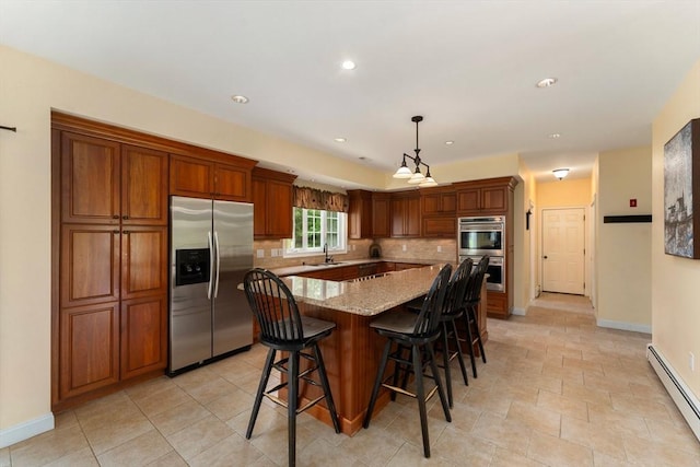 55 Arbor Rd, Uxbridge, MA 01569 - kitchen with stainless steel appliances, a baseboard radiator, a sink, backsplash, and baseboards