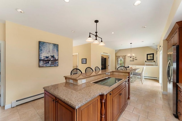 55 Arbor Rd, Uxbridge, MA 01569 - kitchen with a baseboard heating unit, black electric stovetop, freestanding refrigerator, a kitchen island with sink, and recessed lighting