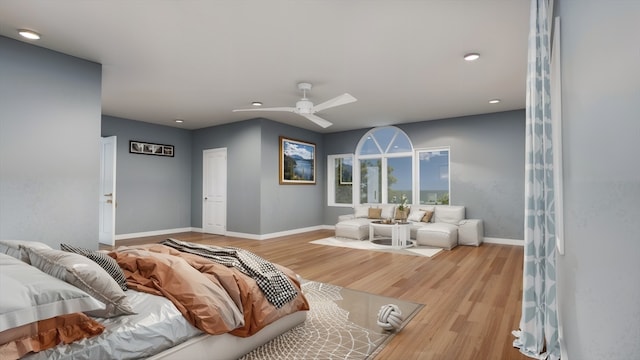 bedroom with light hardwood / wood-style floors and ceiling fan