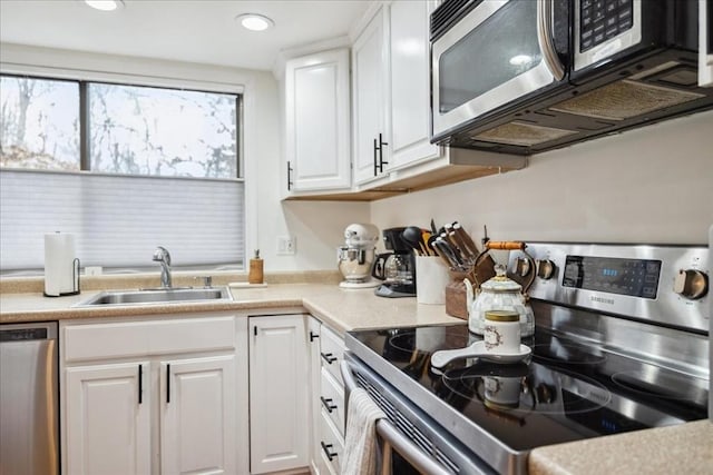 kitchen featuring a sink, white cabinetry, recessed lighting, appliances with stainless steel finishes, and light countertops