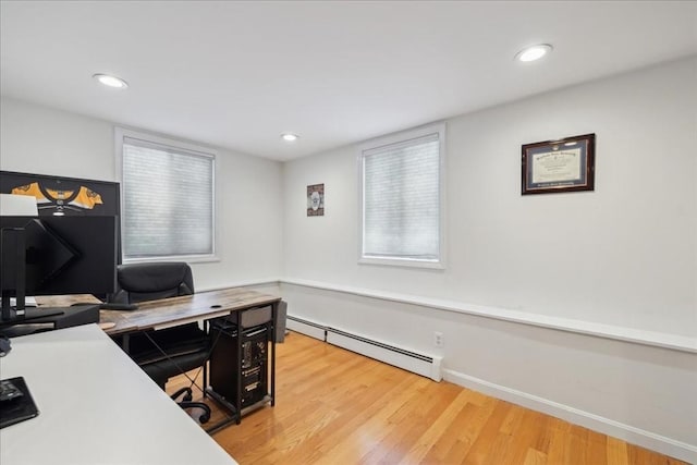 office space featuring recessed lighting, light wood-style floors, baseboards, and a baseboard radiator