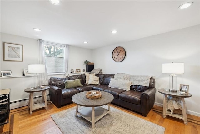 living area with light wood-style flooring, recessed lighting, baseboards, and baseboard heating