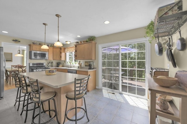 42 Mcgregory Rd, Sturbridge, MA 01566 - kitchen with appliances with stainless steel finishes, light countertops, a breakfast bar area, light tile patterned flooring, and recessed lighting