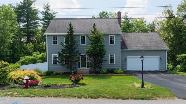 42 Mcgregory Rd, Sturbridge, MA 01566 - colonial house featuring an attached garage, a chimney, driveway, entry steps, and roof with shingles