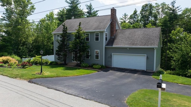 42 Mcgregory Rd, Sturbridge, MA 01566 - colonial house featuring an attached garage, driveway, a chimney, a front lawn, and roof with shingles