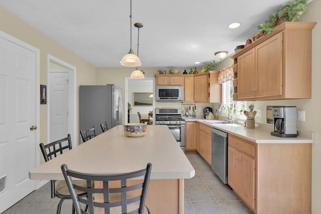 42 Mcgregory Rd, Sturbridge, MA 01566 - kitchen with appliances with stainless steel finishes, light countertops, light tile patterned floors, a center island, and recessed lighting