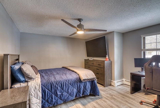 bedroom with a textured ceiling, a ceiling fan, and wood finished floors