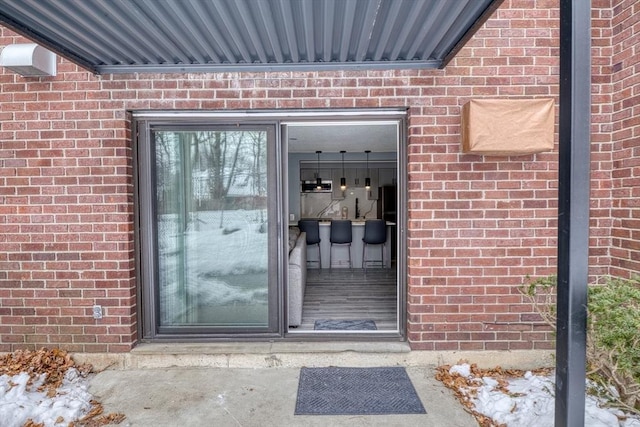 property entrance with brick siding