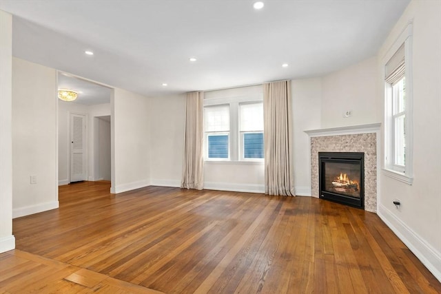 46 Leonard St, Woburn, MA 01801 - unfurnished living room with hardwood / wood-style flooring, a glass covered fireplace, baseboards, and recessed lighting