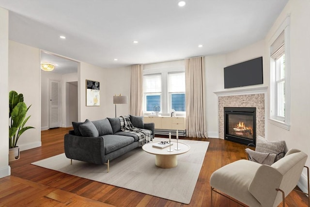 46 Leonard St, Woburn, MA 01801 - living room featuring wood finished floors, a glass covered fireplace, baseboards, recessed lighting, and a baseboard heating unit