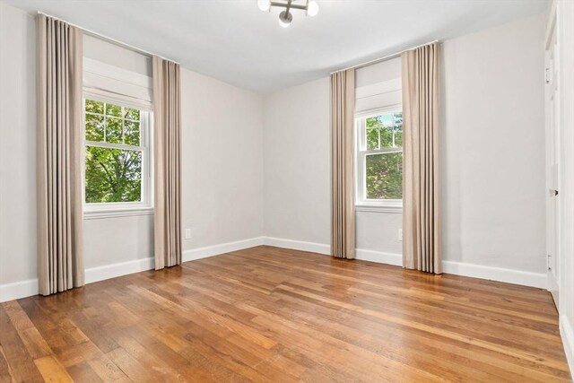 46 Leonard St, Woburn, MA 01801 - empty room featuring plenty of natural light, light wood-type flooring, and baseboards