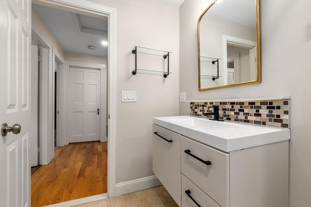 46 Leonard St, Woburn, MA 01801 - bathroom with backsplash, vanity, baseboards, and wood finished floors