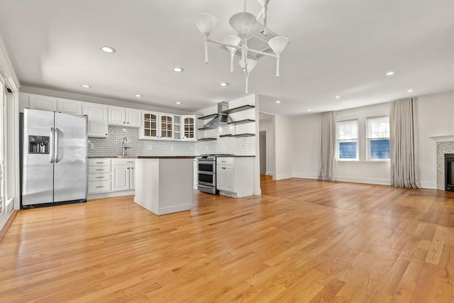 46 Leonard St, Woburn, MA 01801 - kitchen with appliances with stainless steel finishes, a sink, open floor plan, a chandelier, and open shelves