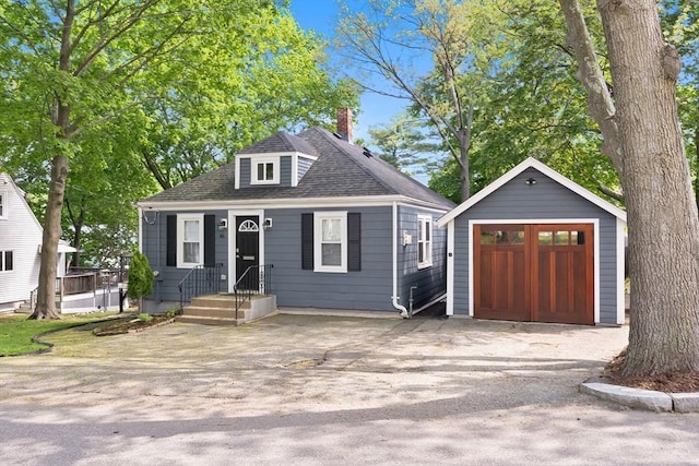 46 Leonard St, Woburn, MA 01801 - view of front of property featuring a garage, an outbuilding, a shingled roof, and a chimney