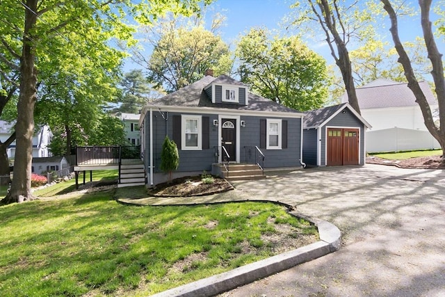46 Leonard St, Woburn, MA 01801 - view of front of house featuring a front lawn, an outdoor structure, a wooden deck, and a chimney