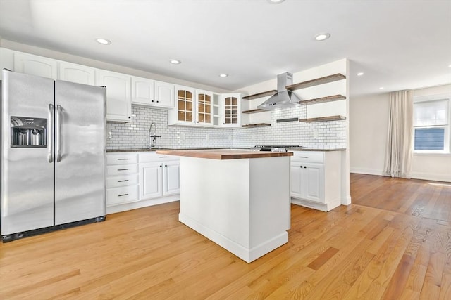 46 Leonard St, Woburn, MA 01801 - kitchen featuring stainless steel appliances, wall chimney range hood, open shelves, white cabinetry, and decorative backsplash