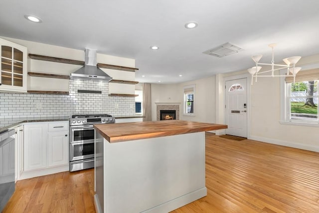 46 Leonard St, Woburn, MA 01801 - kitchen with appliances with stainless steel finishes, wood counters, wall chimney range hood, open shelves, and light wood-style floors