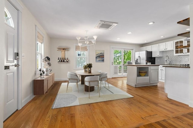 46 Leonard St, Woburn, MA 01801 - dining area with light wood finished floors, baseboards, a chandelier, and recessed lighting