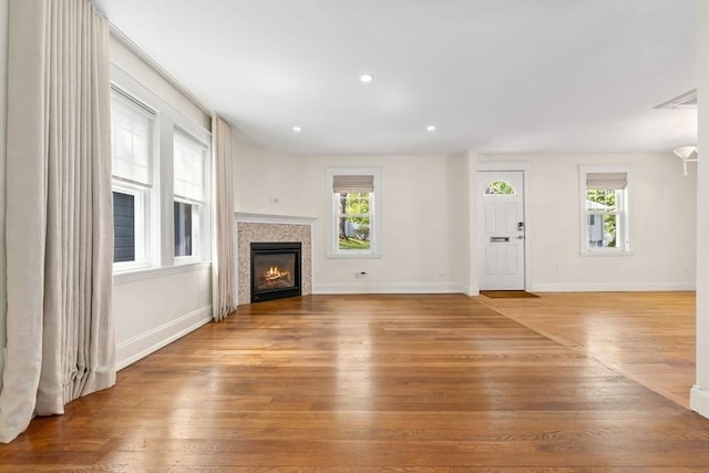 46 Leonard St, Woburn, MA 01801 - unfurnished living room with a glass covered fireplace, light wood-style flooring, baseboards, and recessed lighting