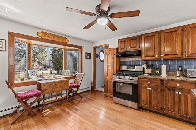 125 Wamsutta Rd, Eastham, MA 02642 - kitchen featuring gas range, under cabinet range hood, a baseboard radiator, tasteful backsplash, and ceiling fan