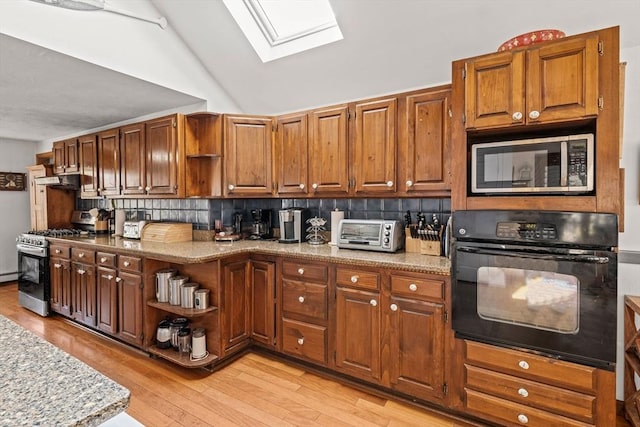 125 Wamsutta Rd, Eastham, MA 02642 - kitchen with stainless steel appliances, open shelves, a skylight, decorative backsplash, and light wood-type flooring