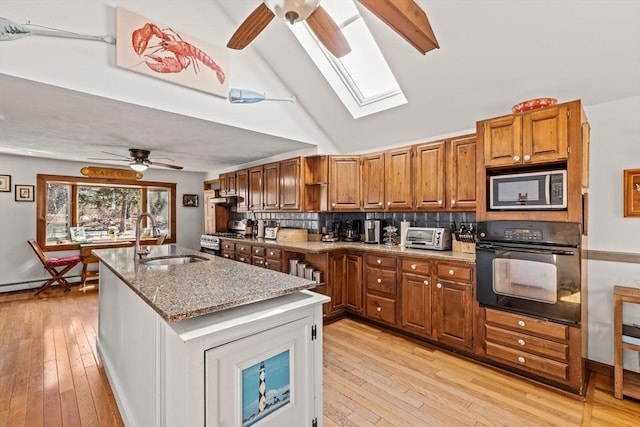 125 Wamsutta Rd, Eastham, MA 02642 - kitchen featuring stainless steel appliances, a ceiling fan, a sink, brown cabinetry, and high vaulted ceiling