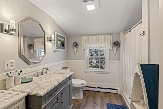 125 Wamsutta Rd, Eastham, MA 02642 - bathroom with baseboard heating, wood finished floors, vaulted ceiling, toilet, and a wainscoted wall