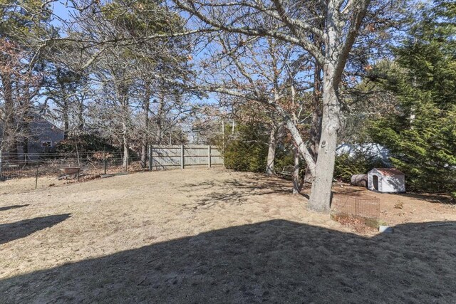 125 Wamsutta Rd, Eastham, MA 02642 - view of yard featuring a storage shed, fence, and an outbuilding
