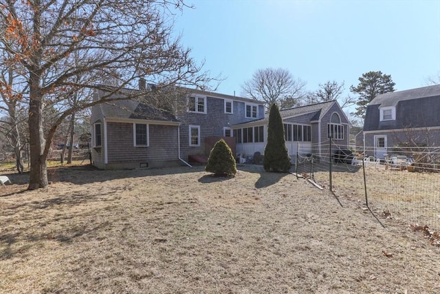 125 Wamsutta Rd, Eastham, MA 02642 - rear view of house with a sunroom and fence