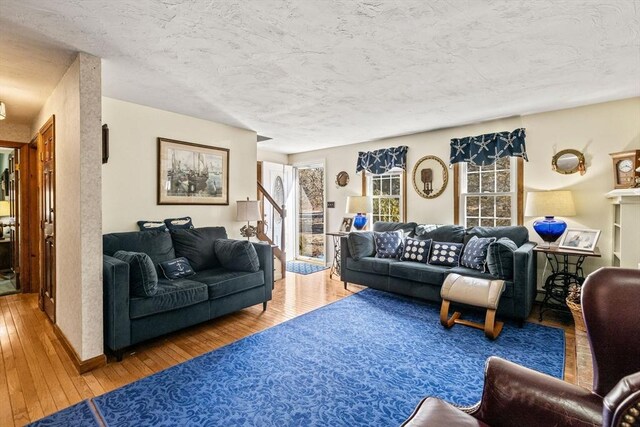 125 Wamsutta Rd, Eastham, MA 02642 - living area with wood-type flooring, plenty of natural light, and a textured ceiling