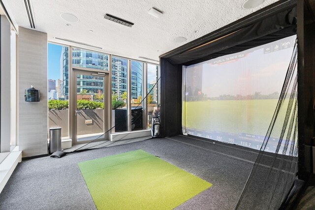 interior space featuring golf simulator and a water view