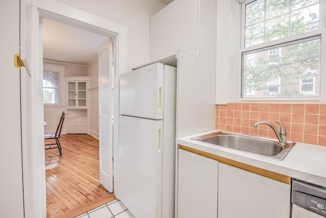 34 Garrison Rd Unit 4, Brookline, MA 02445 - kitchen featuring freestanding refrigerator, a sink, light countertops, and white cabinets