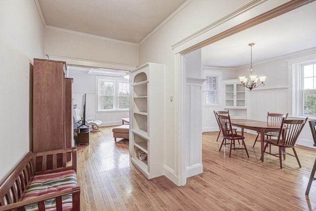 34 Garrison Rd Unit 4, Brookline, MA 02445 - hall featuring light wood-type flooring, a wainscoted wall, ornamental molding, a decorative wall, and a chandelier